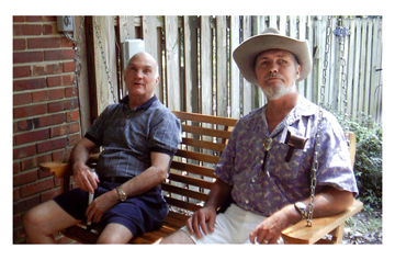 Carl McCoy and William Benjamin sitting on porch swing